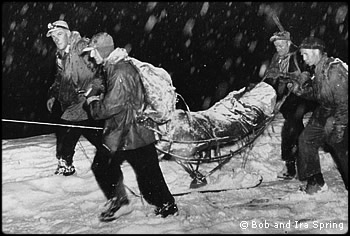 Kurt Beam, Otto Trott, Al Krupp, and Wolf Bauer (L-R) rescue Bill Degenhardt in a Stokeski litter after he broke his hip in an avalanche on Mt Snoqualmie, 1954. Photo courtesy The Spring Family Trust for Trails. (http://www.springtrailtrust.org)