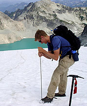 Probing snow depth on a glacier. Photo © Mauri Pelto