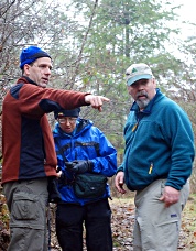 Paul Klenke and John Roper discuss the route in Fort Lewis while Fay Pullen checks the GPS. Photo © Michelle Rowley Klenke.