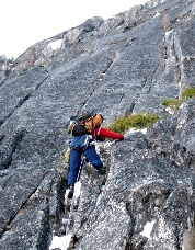 John Plotz climbing above the off-width in mostly dry conditions. Photo © Ade Miller.