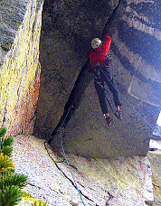 Sol Wertkin climbing the 25-ft roof on aid, Colchuck Balanced Rock. Photo © Blake Herrington.