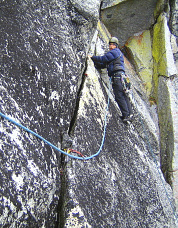 Blake Herrington leads out above the roof pitch, Colchuck Balanced Rock. Photo © Sol Wertkin.