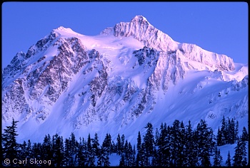 Mount Shuksan at dusk, with the Hanging Glacier at center. Photo © Carl Skoog.