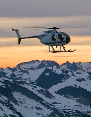 Pilot Tony Reece arrives in the helicopter at sunset. Photo © Steph Abegg.